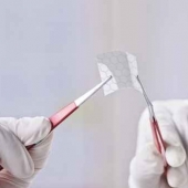 Scientific showing a piece of graphene with hexagonal molecule.